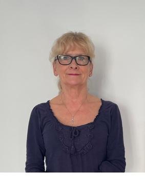 Photo shows lady smiling wearing glasses and sweetheart next black top